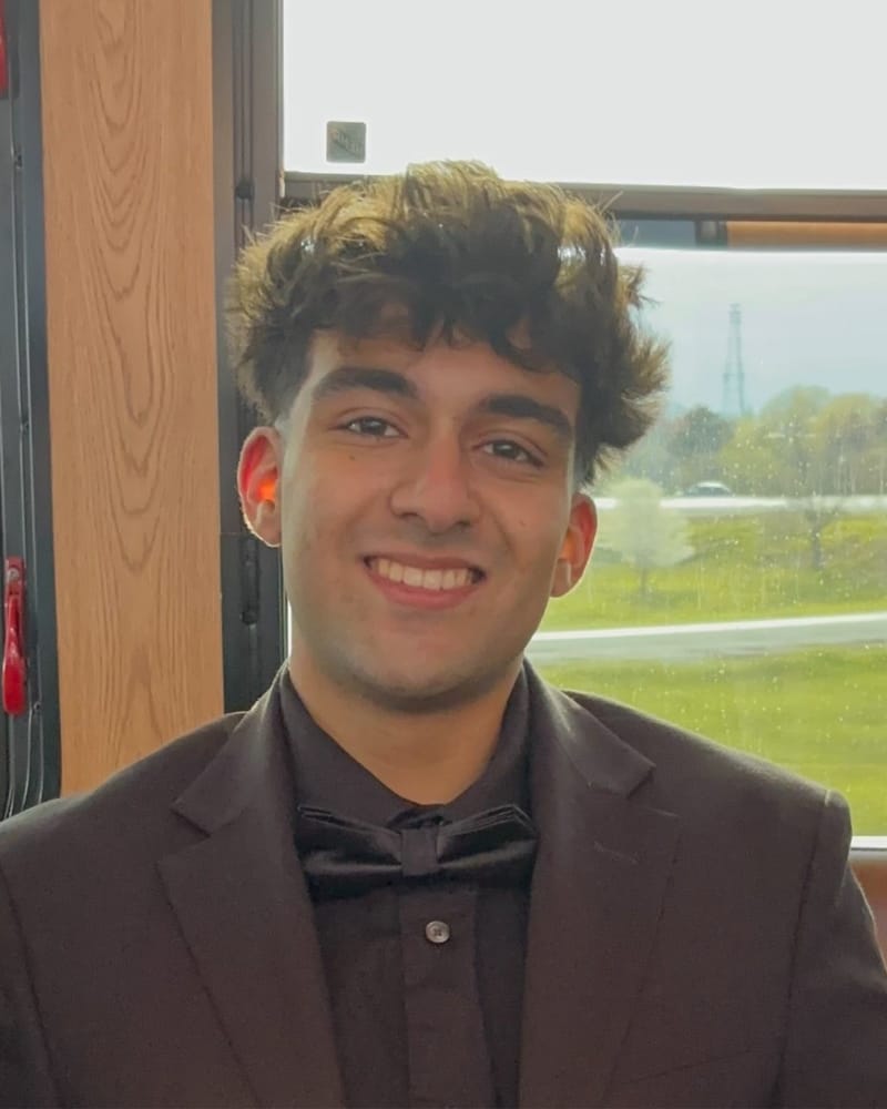 Mahir Patel, smiling, in a dark suit and bow tie.